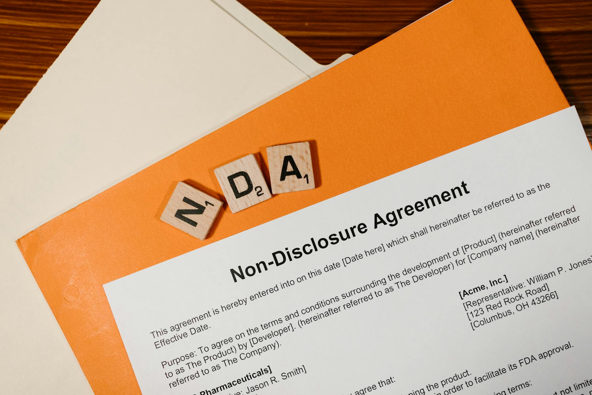Non-Disclosure Agreement (NDA) Drafting – NDA document with letter tiles